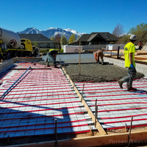 Hydronic Heating Systems: Seven things you'll want to know 13 Construction site pouring concrete foundation with radiant hydronic heating system and workers in safety gear.